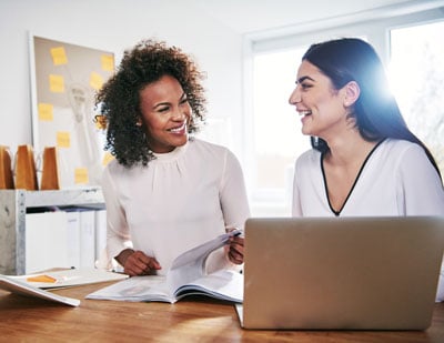 two-cheerful-businesswomen-at-laptop-with-document-2021-08-30-02-30-38-utc