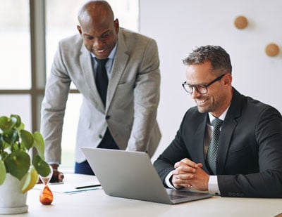 two-smiling-businessmen-talking-together-and-worki-2021-08-30-02-34-36-utc-1